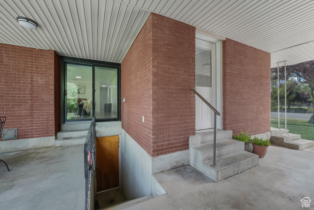 Doorway to property with brick siding