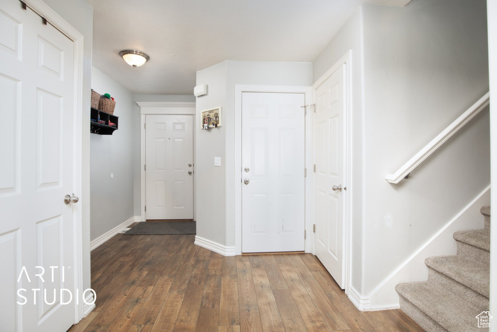 Entryway with wood-type flooring and stairway