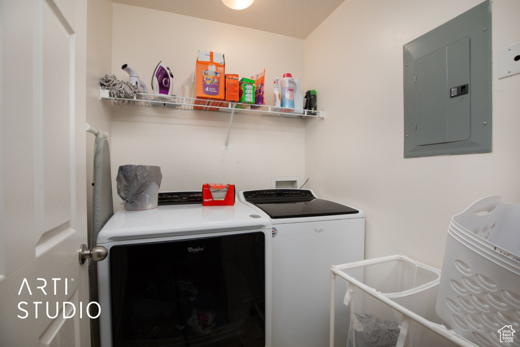 Laundry room featuring electric panel and independent washer and dryer