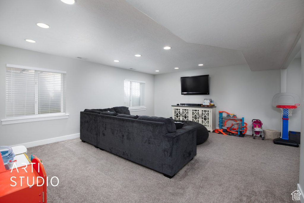 Carpeted living room with recessed lighting and baseboards