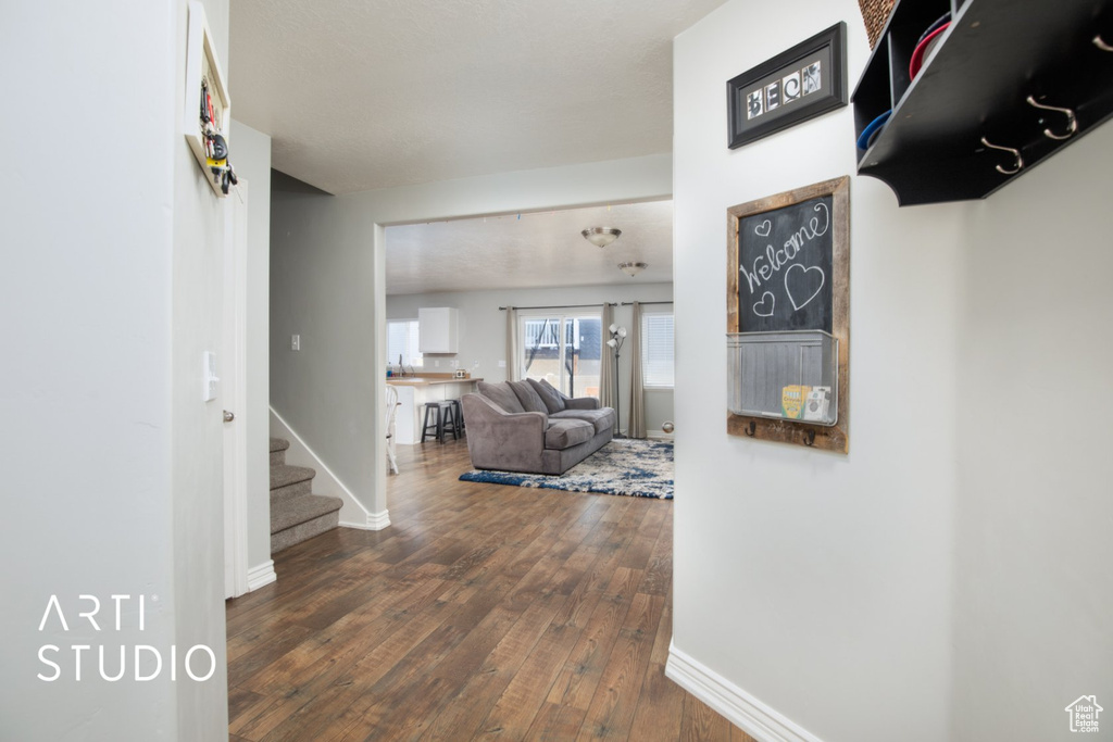 Corridor featuring hardwood / wood-style flooring and stairway
