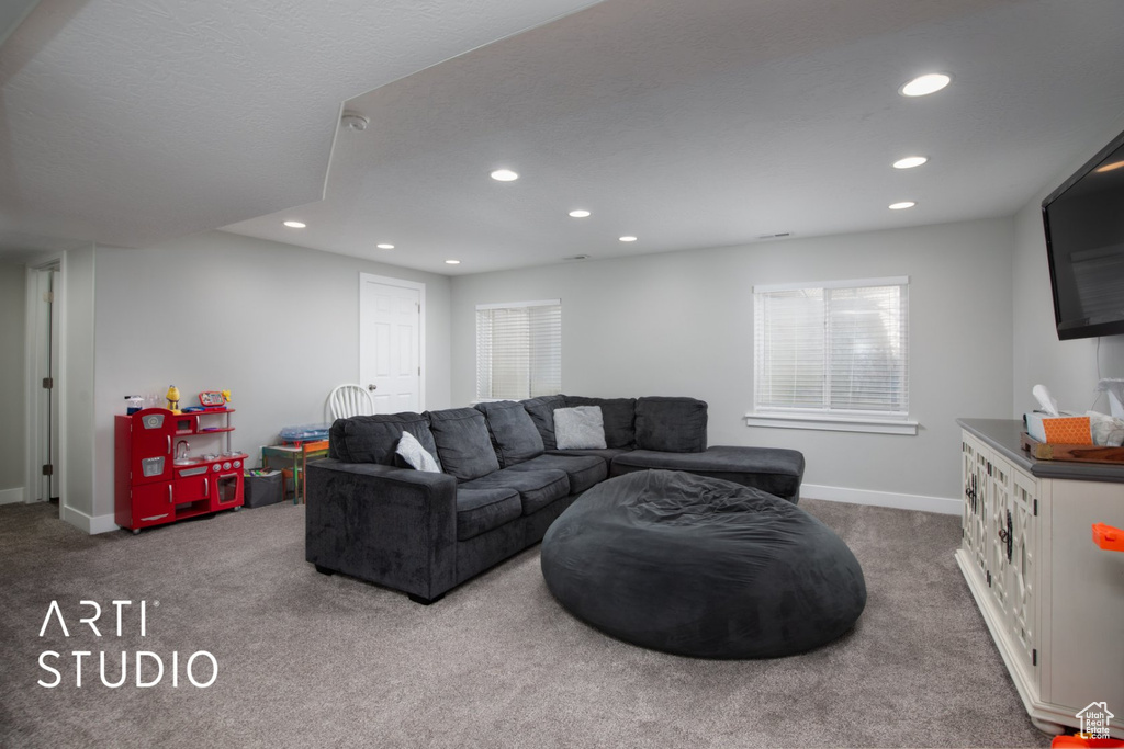 Carpeted living area featuring recessed lighting