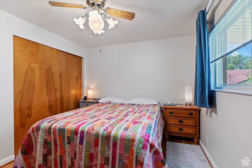 Bedroom with wood finished floors and a ceiling fan