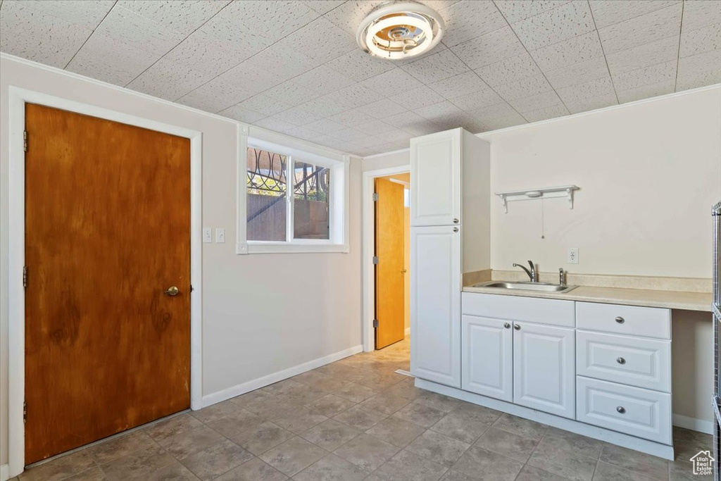 Interior space featuring a sink and baseboards