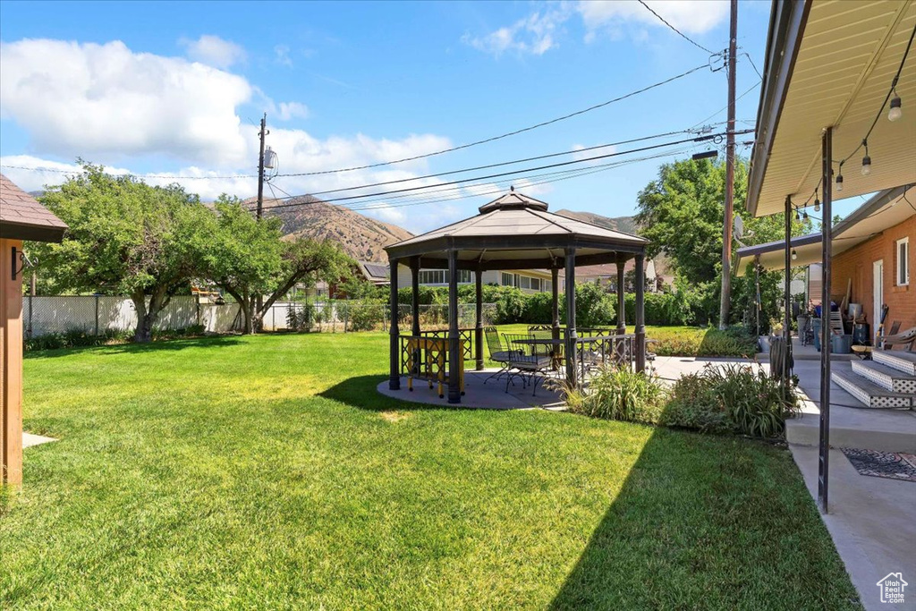 View of yard with a gazebo and a patio area