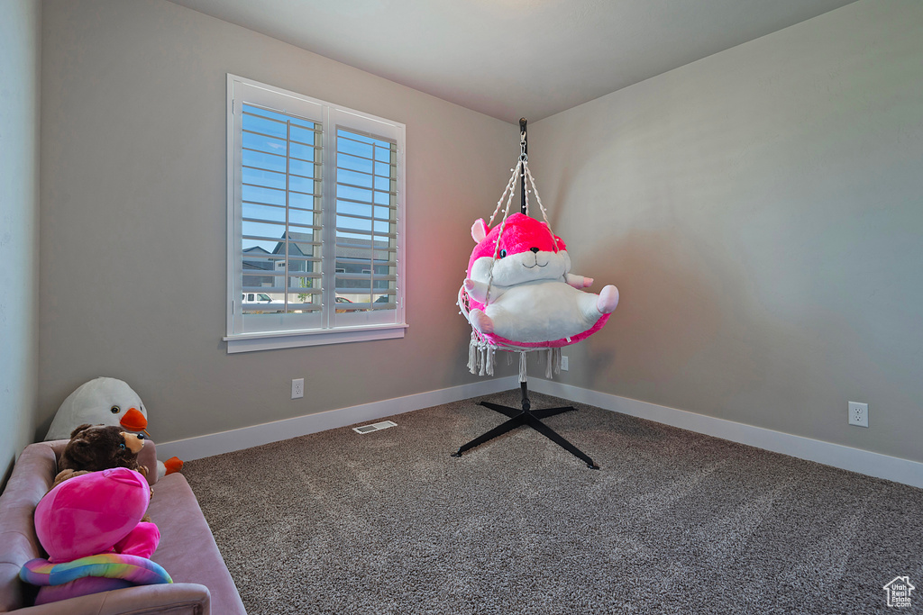 Playroom with baseboards and carpet