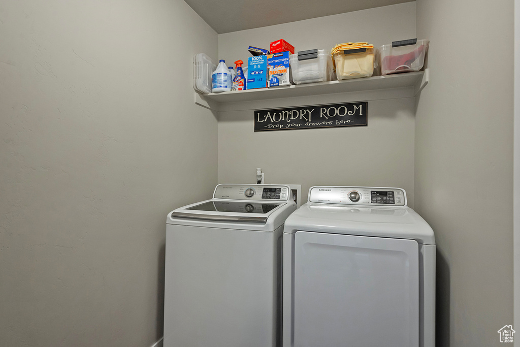 Washroom featuring washing machine and dryer