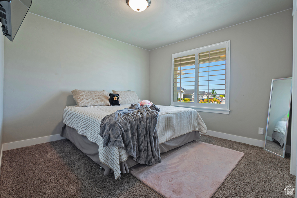 Carpeted bedroom with baseboards