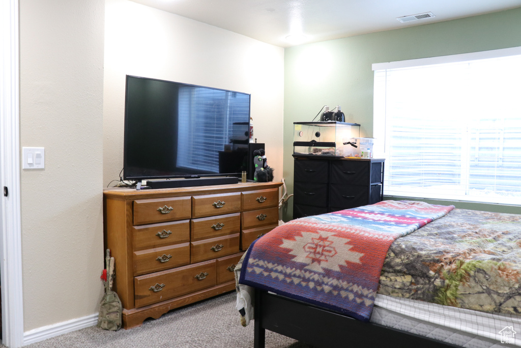 Carpeted bedroom with baseboards