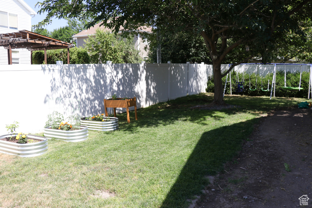 View of yard featuring a garden and a pergola