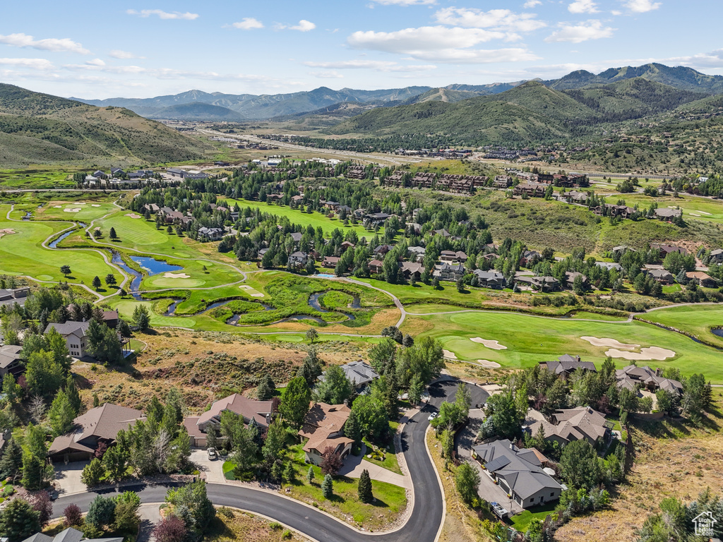 Aerial perspective of suburban area featuring a local golf course and a water and mountain view