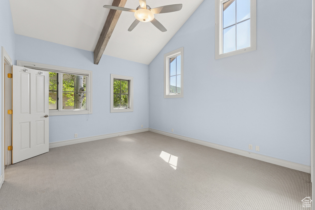 Carpeted spare room featuring a ceiling fan and baseboards