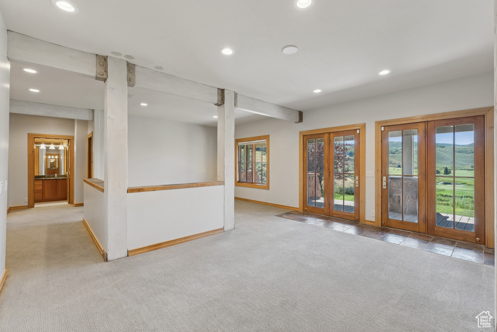 Carpeted spare room with french doors and recessed lighting