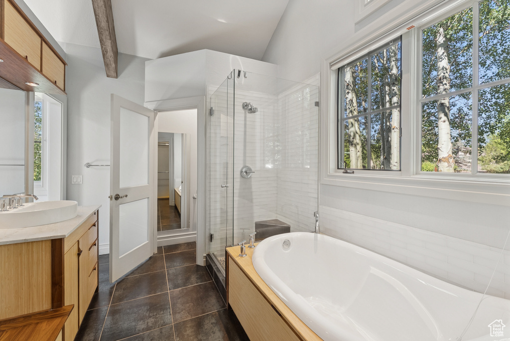 Bathroom with vanity, a shower stall, a garden tub, and tile patterned floors