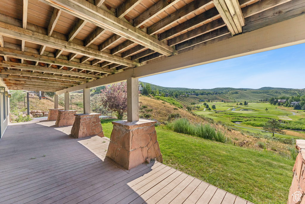 Deck featuring a mountain view and a yard