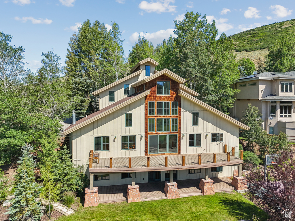 Rear view of property featuring board and batten siding and a patio area