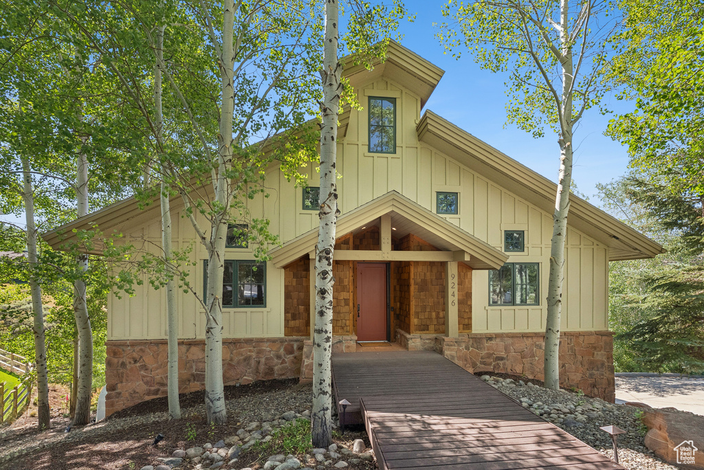 View of front facade with stone siding and board and batten siding