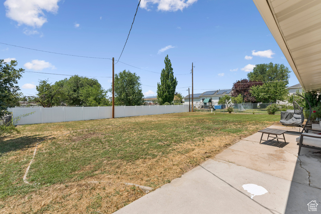 Fenced backyard with a patio area and an outdoor living space