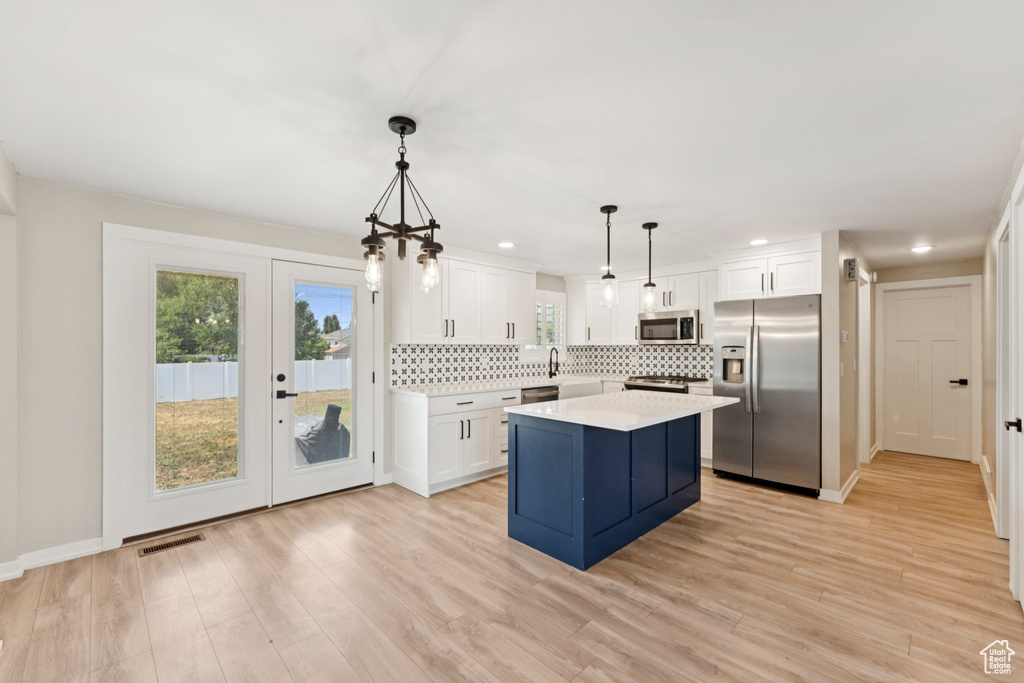 Kitchen with appliances with stainless steel finishes, light countertops, backsplash, plenty of natural light, and recessed lighting