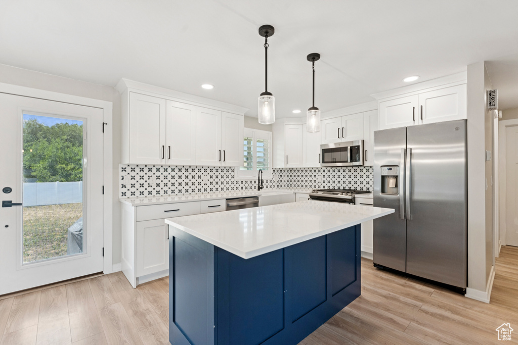 Kitchen featuring stainless steel appliances, light wood-style flooring, white cabinetry, plenty of natural light, and recessed lighting
