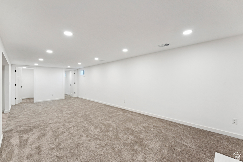 Finished basement featuring recessed lighting and light carpet