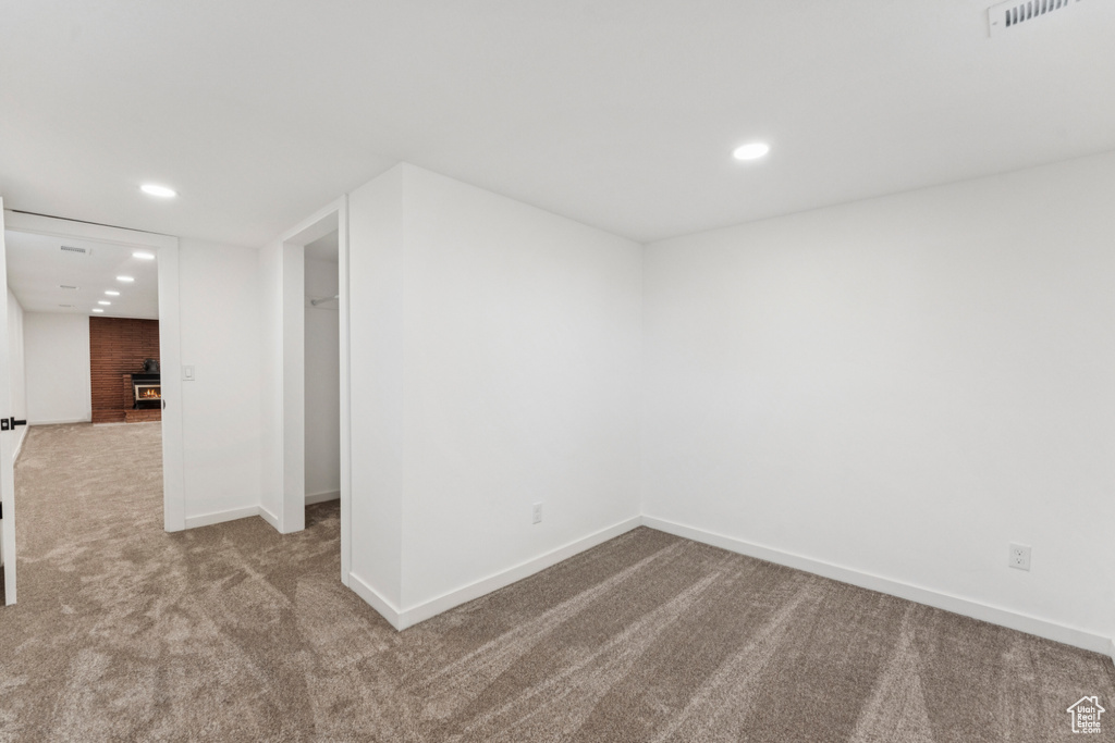 Carpeted empty room featuring baseboards and recessed lighting