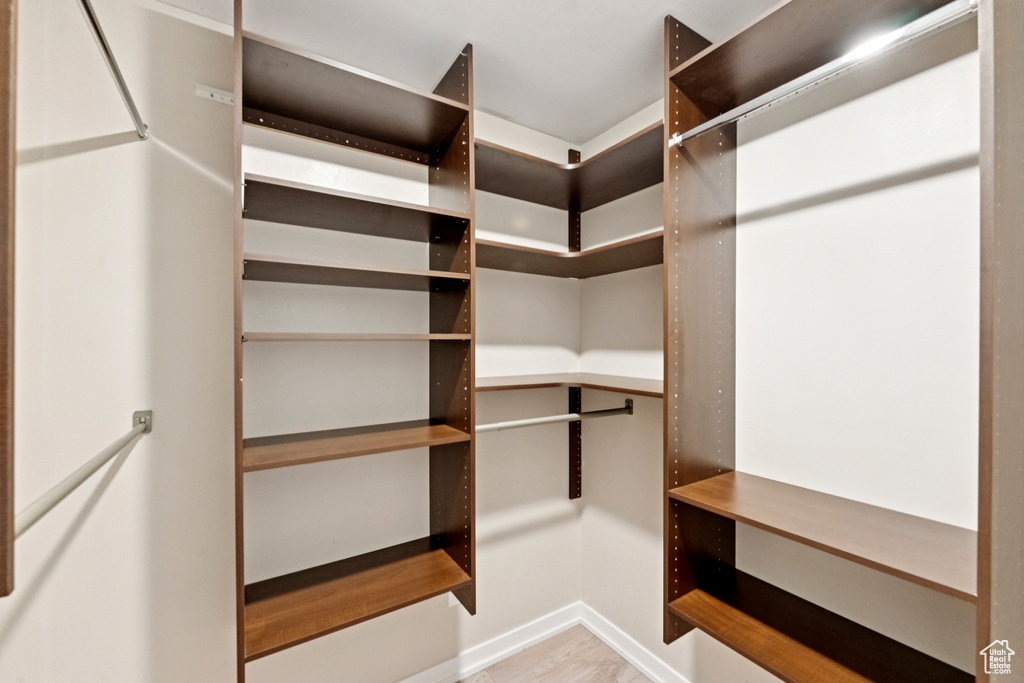 Walk in closet featuring wood finished floors