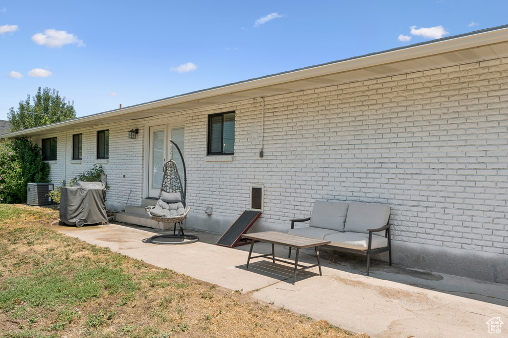 Rear view of house with a patio area and brick siding