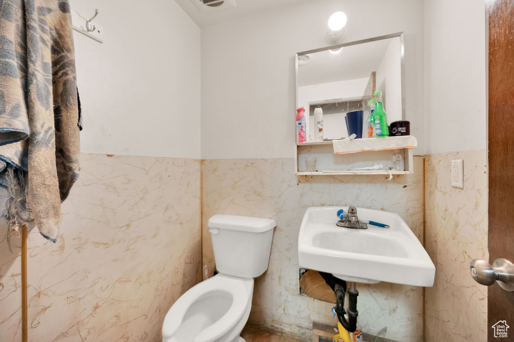 Bathroom with wainscoting and tile walls
