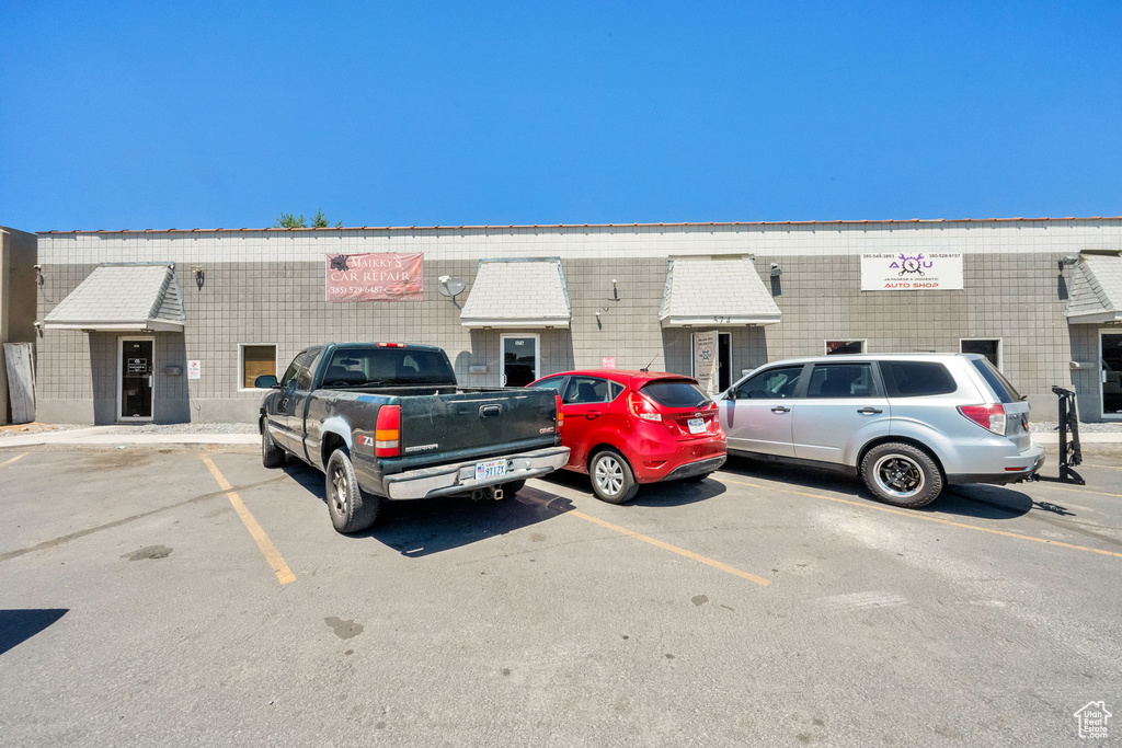View of property featuring uncovered parking