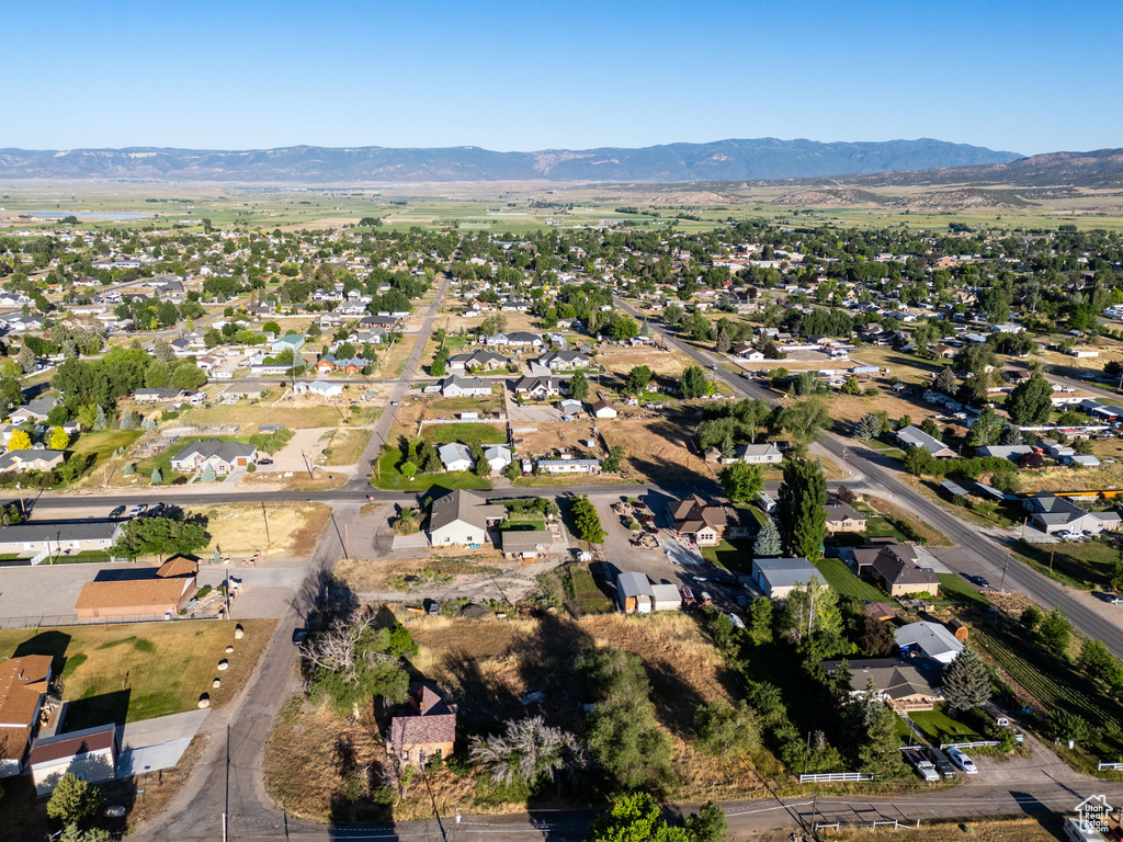 Aerial overview of property\\\'s location featuring a mountain backdrop and nearby suburban area