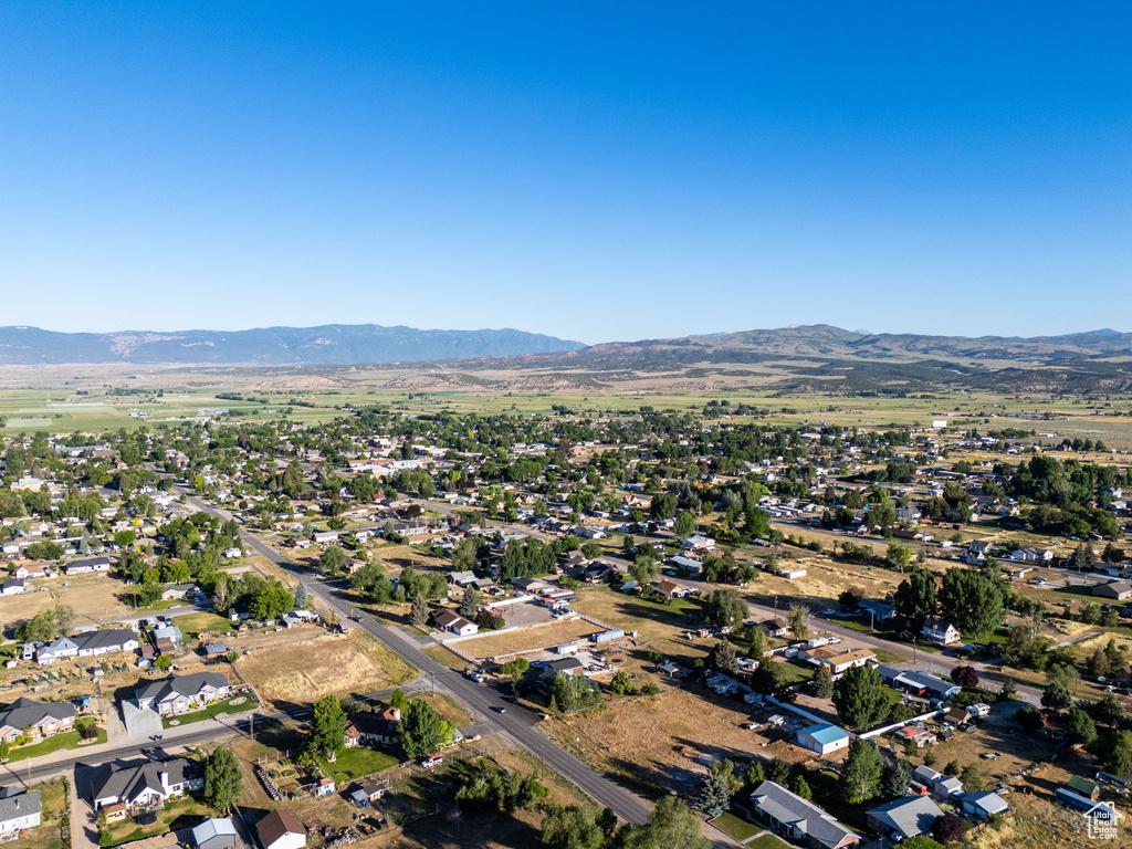 Aerial overview of property\'s location with a mountainous background and nearby suburban area