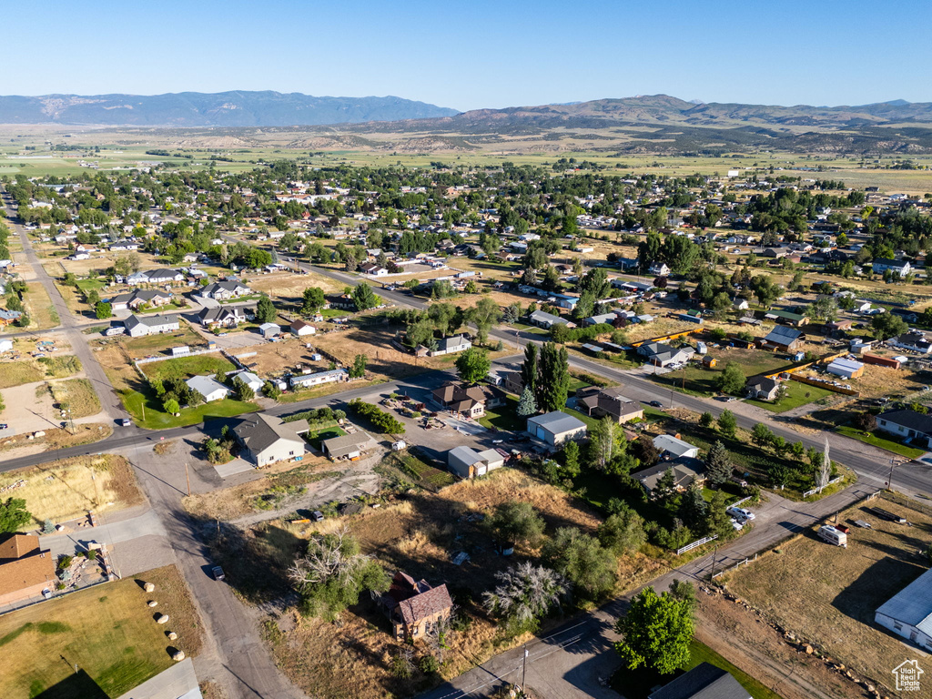 Aerial view of property\'s location with a mountain backdrop and nearby suburban area