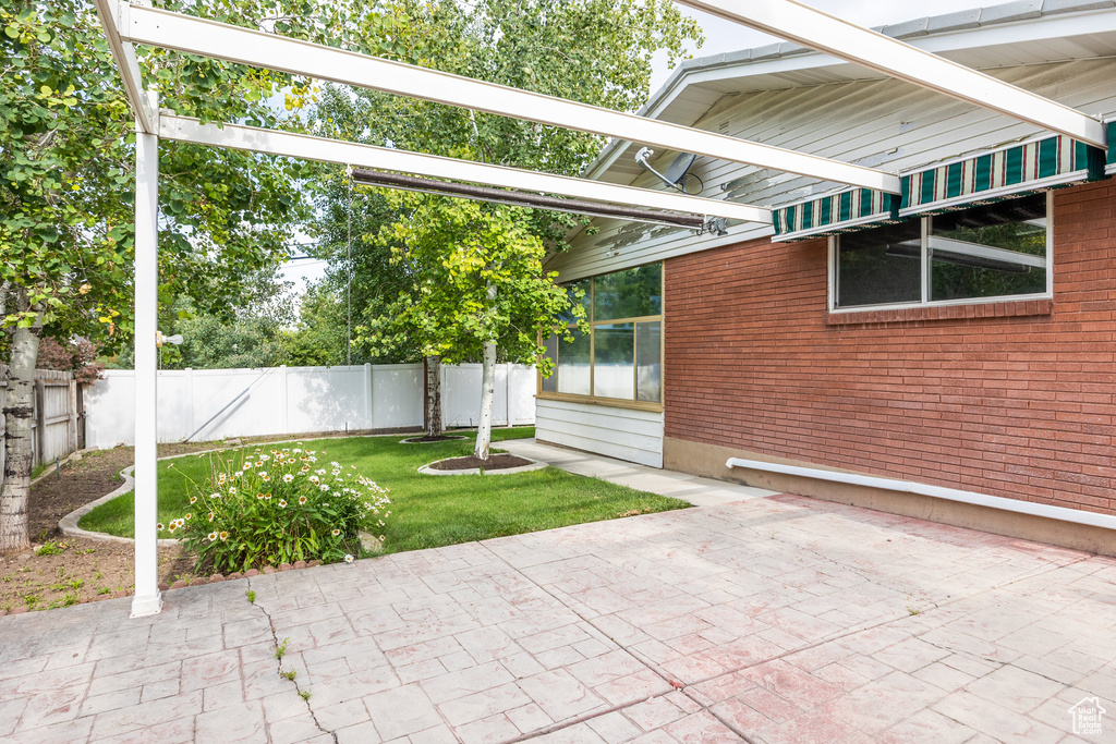Fenced backyard with a patio