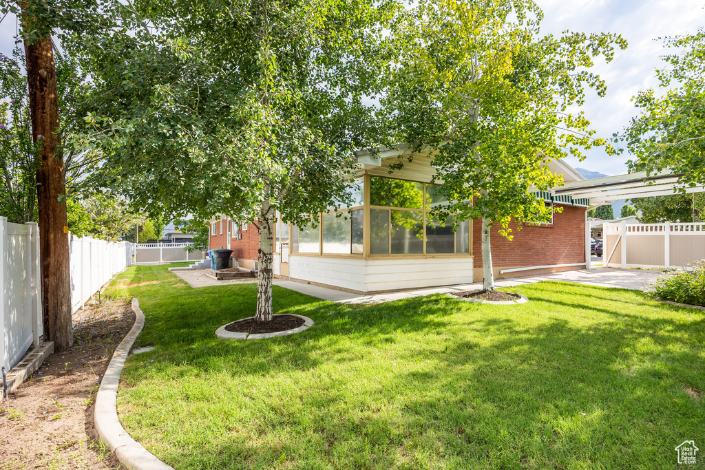 Fenced backyard featuring a patio