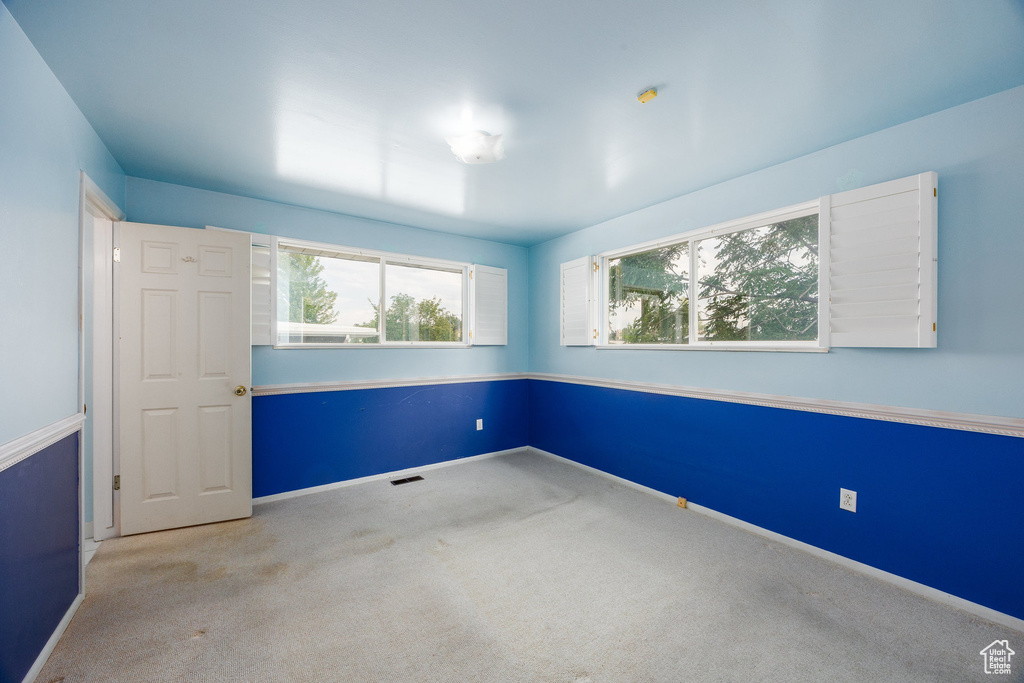 Spare room with carpet and baseboards