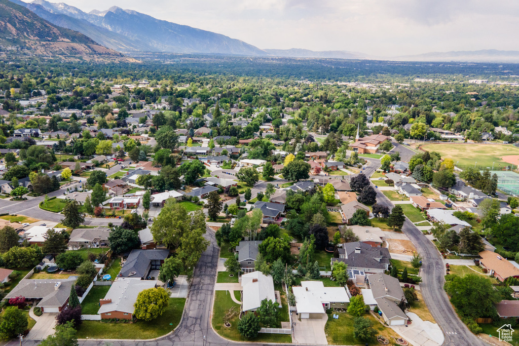 Aerial view of property's location with a mountainous background and nearby suburban area