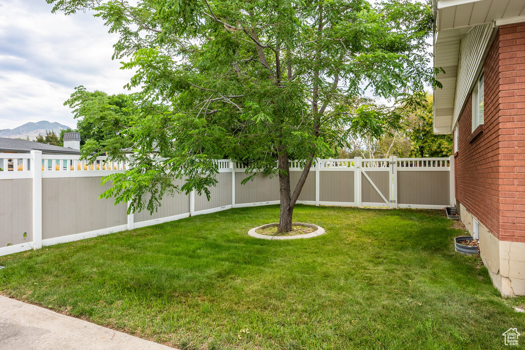 Fenced backyard featuring a mountain view