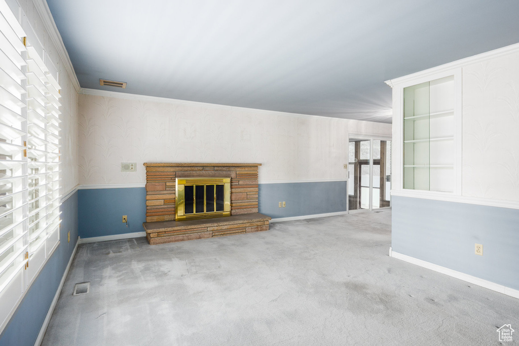 Unfurnished living room featuring a fireplace and carpet floors