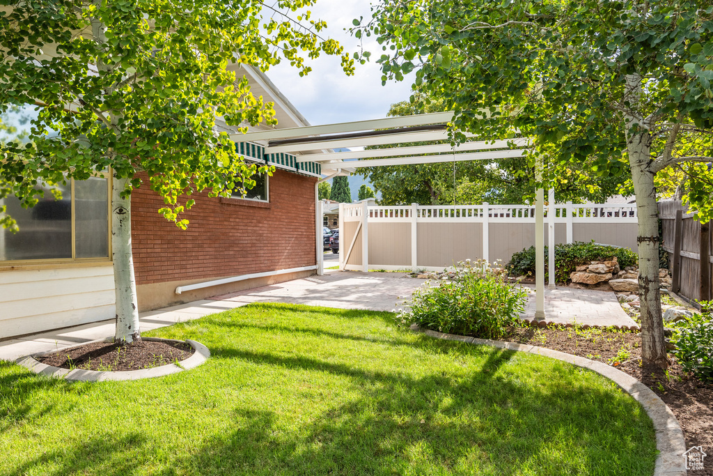 View of yard featuring a patio and a pergola