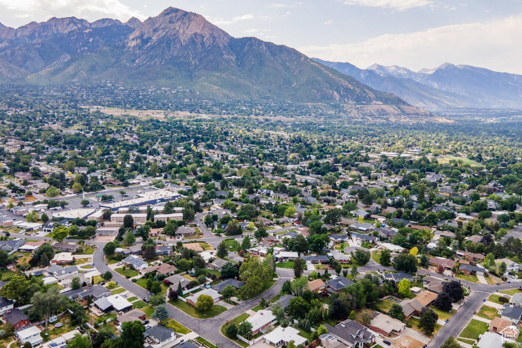 Aerial view of property and surrounding area featuring a mountainous background