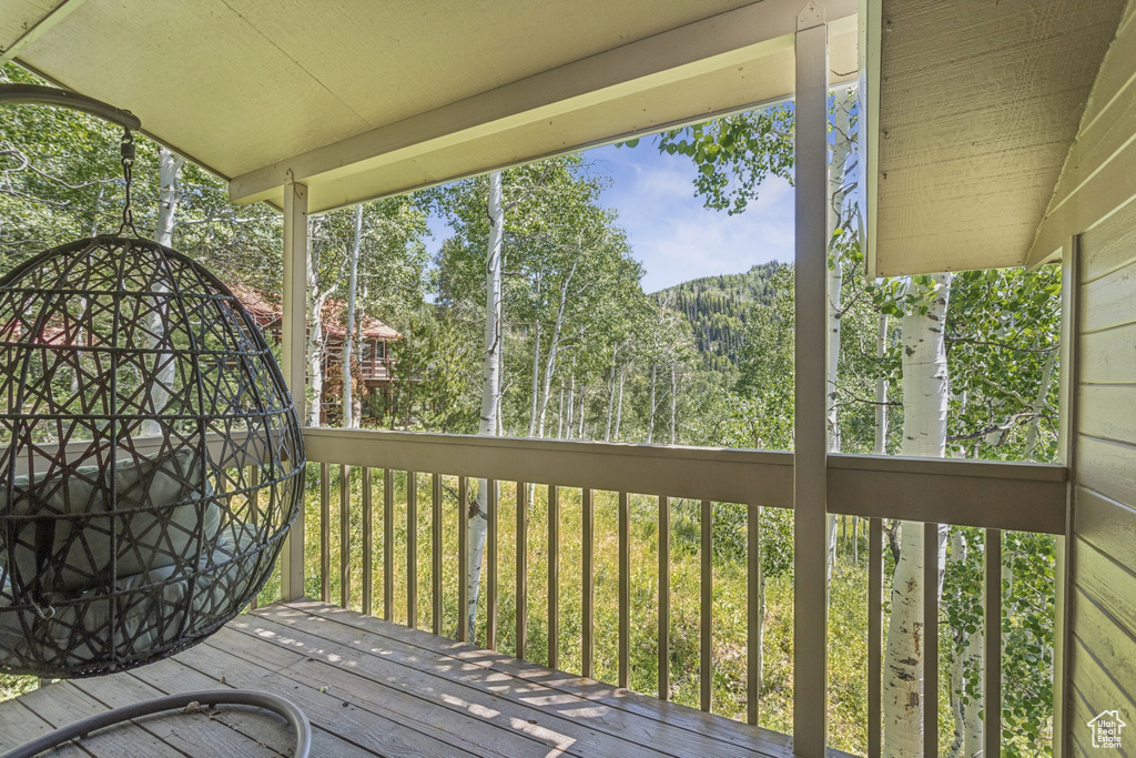 Wooden deck featuring a view of trees