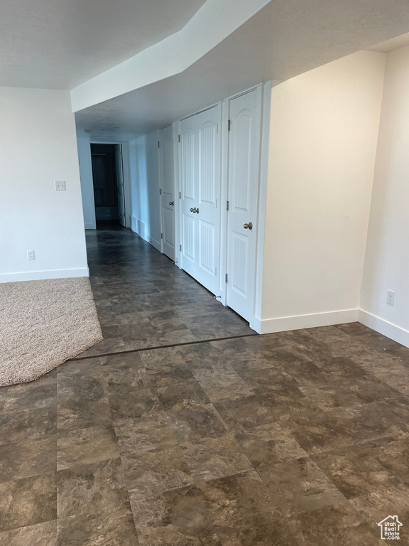 Empty room featuring baseboards and stone finish floors