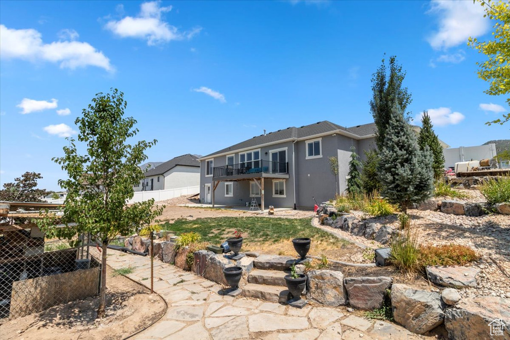 Back of house featuring stucco siding and a patio