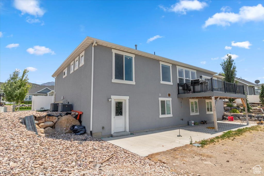 Rear view of house featuring a patio and stucco siding