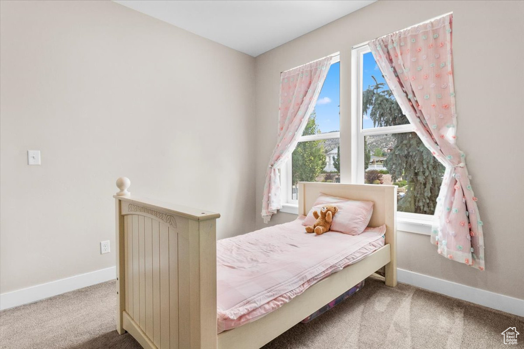Carpeted bedroom featuring baseboards
