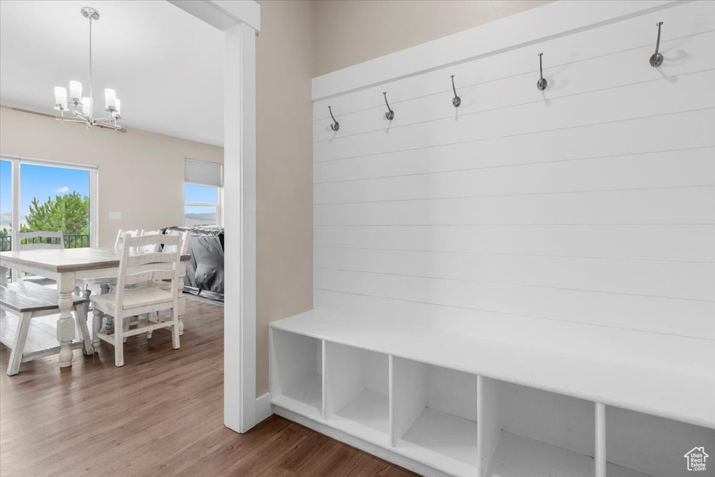 Mudroom with a chandelier and wood finished floors