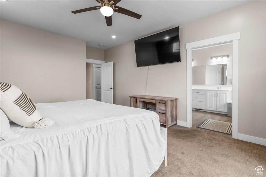Bedroom with light carpet, connected bathroom, recessed lighting, and ceiling fan