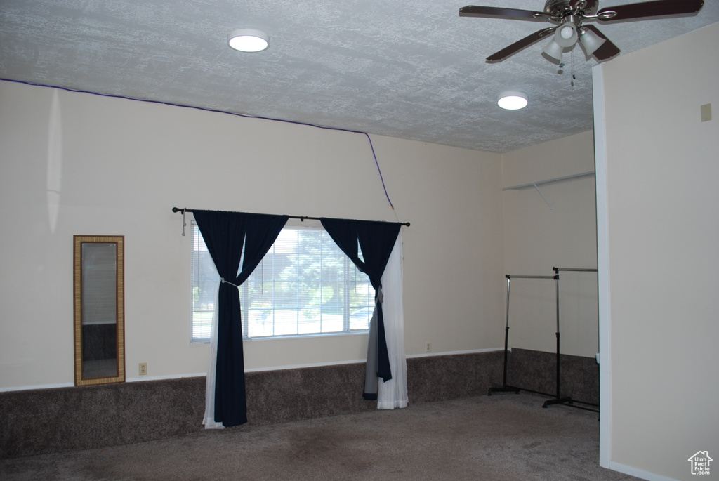Empty room featuring carpet and ceiling fan