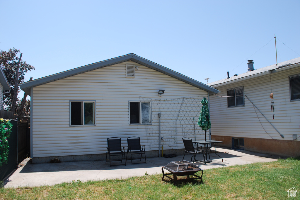 Back of property with a patio area and a fire pit
